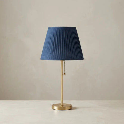 CobaltForm blue pleated fabric table lamp with aged brass stem 1