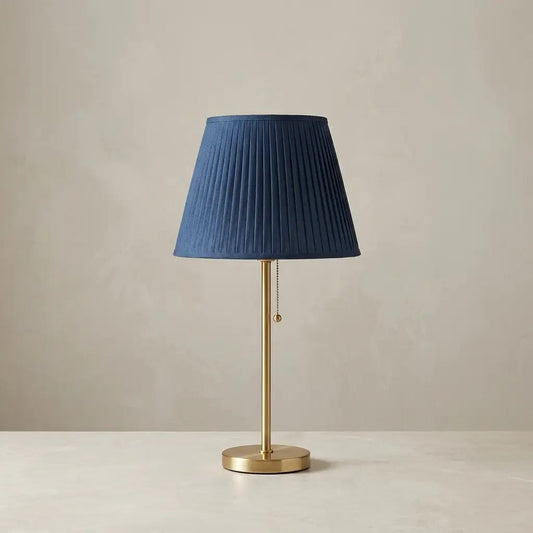 CobaltForm blue pleated fabric table lamp with aged brass stem 1